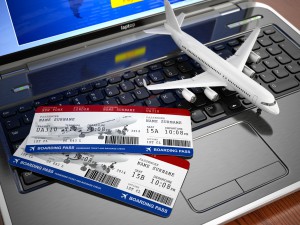 Online ticket booking. Airplane and boarding pass on laptop keyboard. 3d